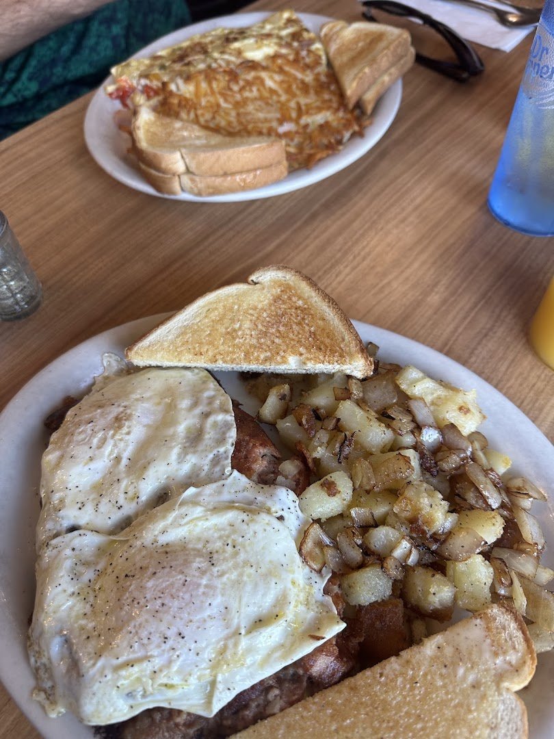 Breakfast plates with omelets and home fries.